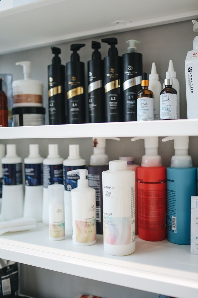 Variety of shampoos and conditioners displayed neatly on a shelf, illustrating that haircare is important as a part of gut health and hair loss .